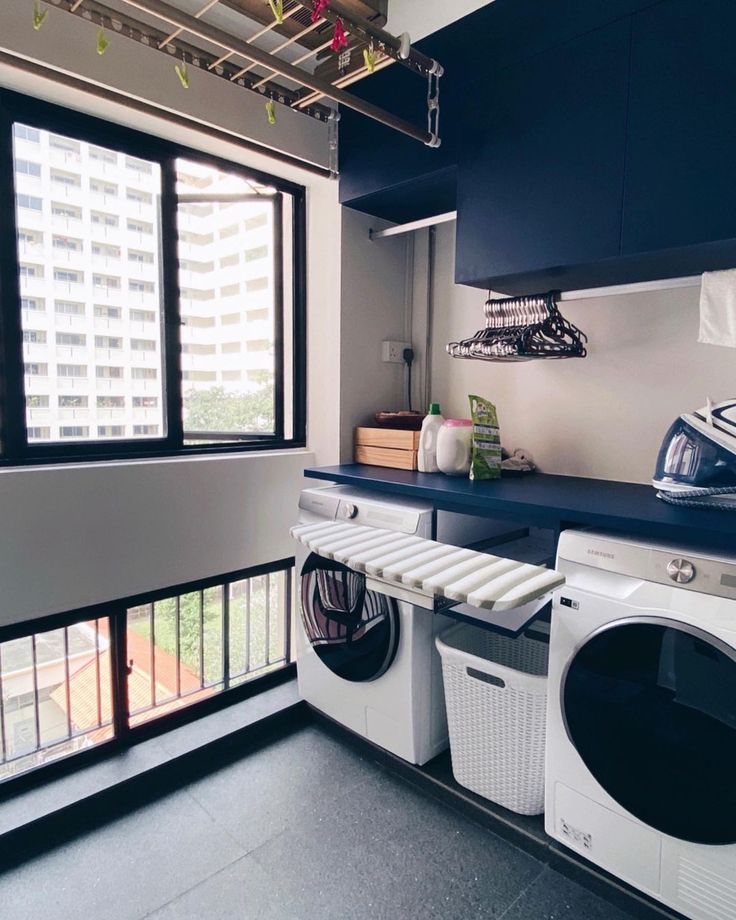 a washer and dryer sitting in a room next to a window with an open door