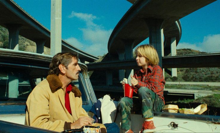 two people sitting in the back of a pick up truck