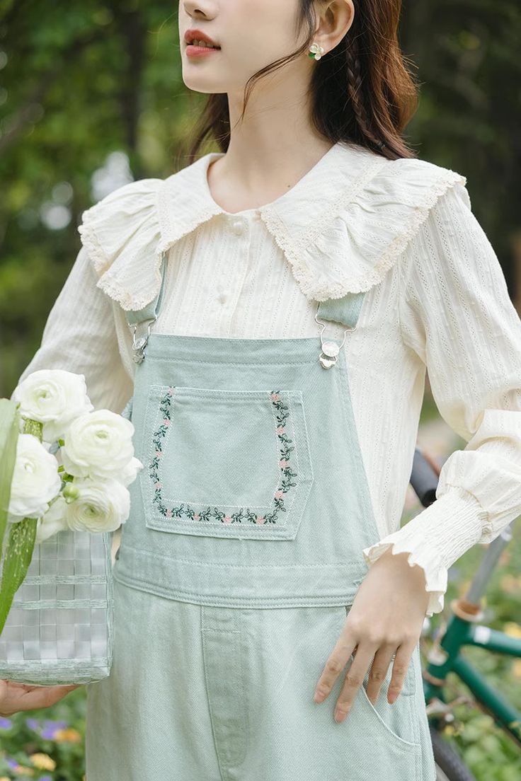 Fresh apple green denim overalls with a flower embroidered bib, button up sides, side pockets and back pockets. S: 32" waist, 39" hips, 23" thighs, 17" ankles, 24.5" inseamM: 33.5" waist, 40.5" hips, 24" thighs, 17.5" ankles, 24.5" inseamL: 35" waist, 42" hips, 25" thighs, 18" ankles, 24.5" inseam How to attach buckles:Slide the rectangular buckle on first, followed by the T-shaped buckle. Overall straps will hold on its own as such or you can slide the free end back into the rectangular buckle. Embroidered Overalls, Flower Vines, Flowering Vines, Shoe Gifts, Apple Green, Overall Dress, Denim Overalls, Sweater Blouse, Cardigan Jacket