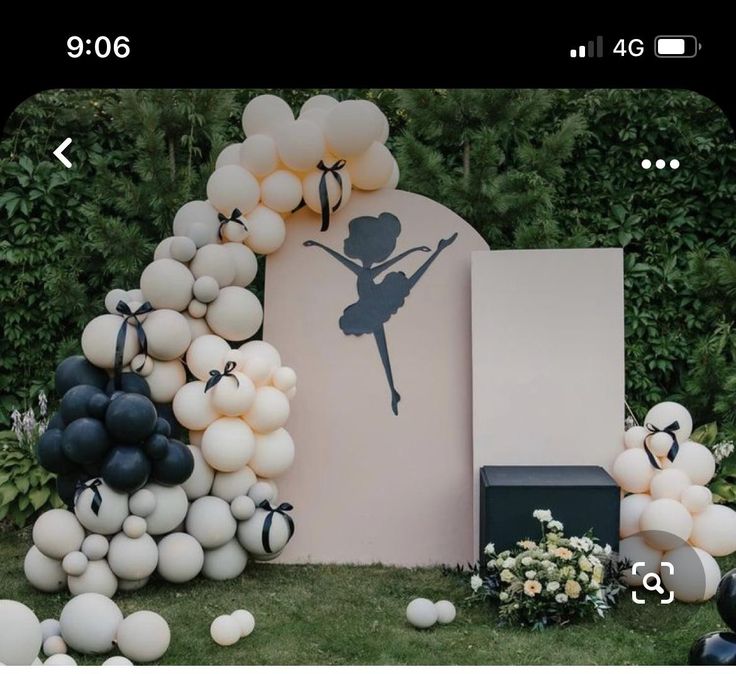 balloons and streamers decorate the entrance to a ballerina themed birthday party