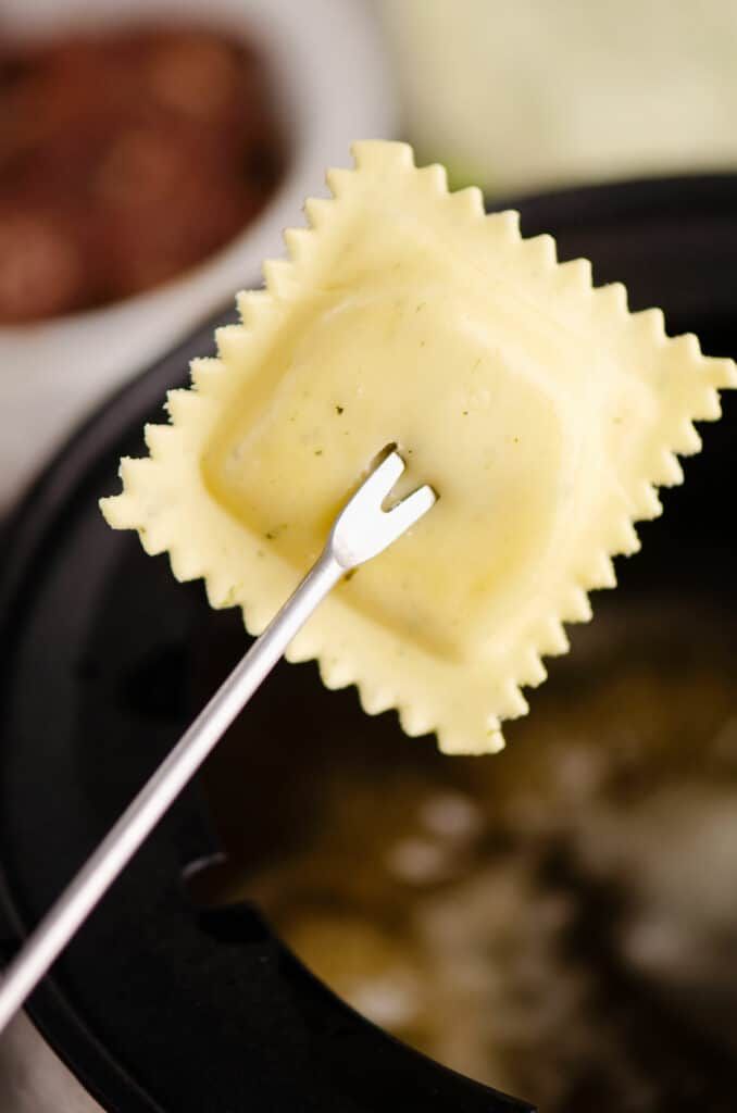 a close up of a pasta dish with a fork in it