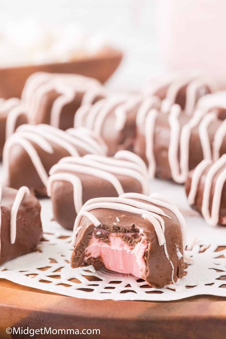 chocolate covered desserts with white icing on a table