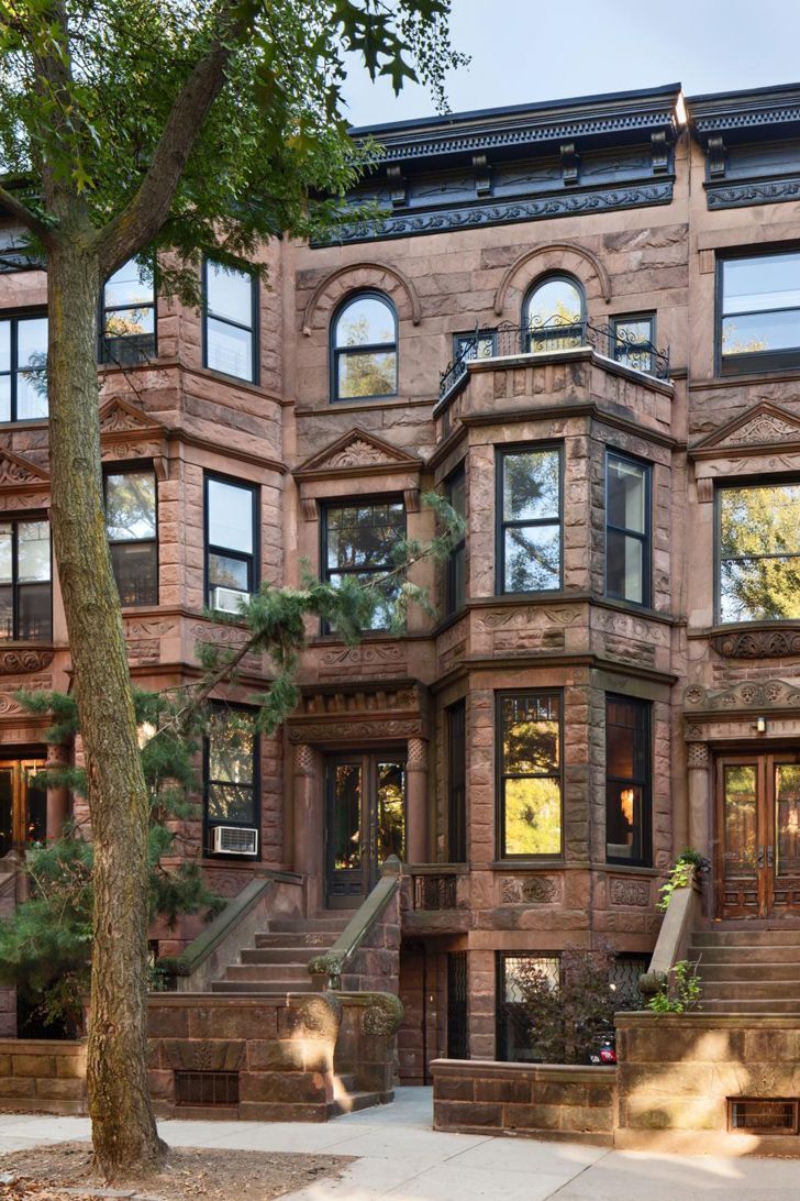 an old brick building with many windows and steps