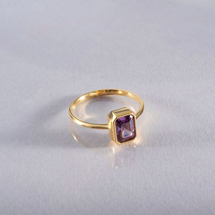 This elegant 14K solid gold ring features a stunning rectangular amethyst, making it a perfect piece of birthstone jewelry. The rich purple hue of the amethyst, which is the birthstone for February, symbolizes clarity, calmness, and spiritual growth. Whether you're celebrating a birthday, anniversary, or any special occasion, this ring makes a thoughtful and unique gift. Its timeless design ensures it will be cherished for years to come. As a Christmas gift, it offers both beauty and personal significance, with the luxurious combination of gold and amethyst creating an elegant look. The deep, vibrant color of the amethyst is beautifully complemented by the warm glow of the solid gold band, making this ring a standout piece in any jewelry collection. Suitable for both everyday wear and spec Yellow Gold Amethyst Ring With Emerald Cut, Rectangular Amethyst Ring In Yellow Gold, Rectangular Yellow Gold Ring With Gemstone, Yellow Gold Rings With Rectangular Gemstone, Rectangular Amethyst Ring For Gift, Classic Octagon Amethyst Ring As A Gift, Gold Amethyst Ring With Emerald Cut, Birthstone, Gold Emerald Cut Amethyst Birthstone Ring, Classic Octagon Amethyst Ring For Gift