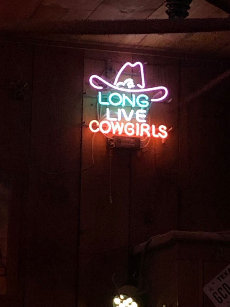 a neon sign that says long live cowgirls