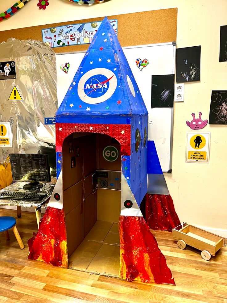 a cardboard rocket ship in the shape of a house