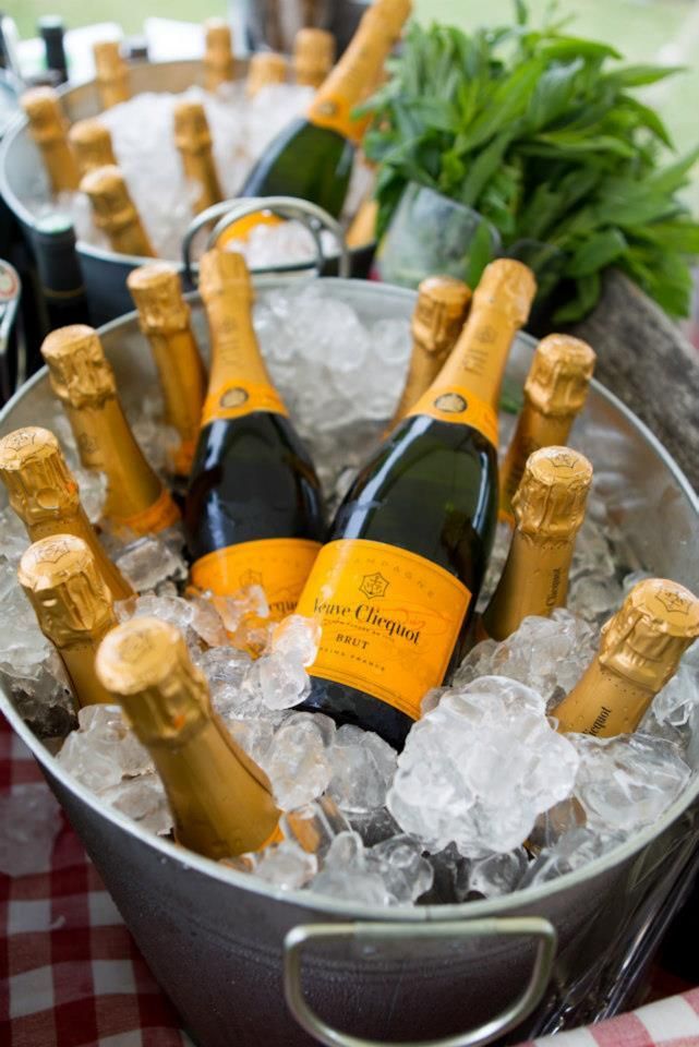 several bottles of champagne are in an ice bucket