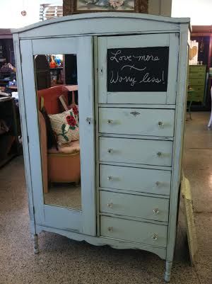 a blue armoire with writing on it