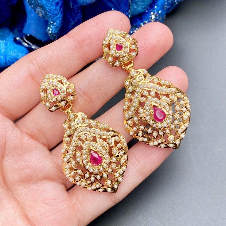 INTRICATE PEARL EARRINGS Traditional Red Pearl Earrings For Formal Occasions, Elegant Ruby Earrings For Reception, Ruby Drop Earrings Temple Jewelry, Elegant Ruby Earrings For Festivals, Elegant Red Pearl Earrings For Festivals, Elegant Red Danglers For Wedding, Red Kundan Earrings For Reception, Gold Meenakari Ruby Earrings, Gold Meenakari Earrings With Ruby