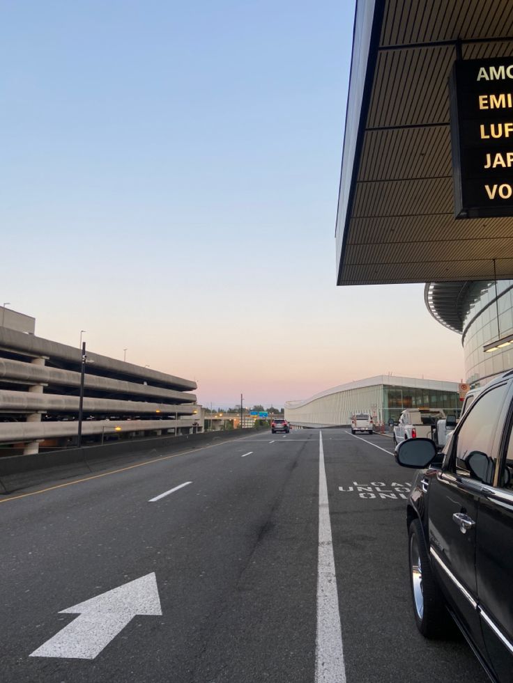 an airport with cars parked on the side of the road