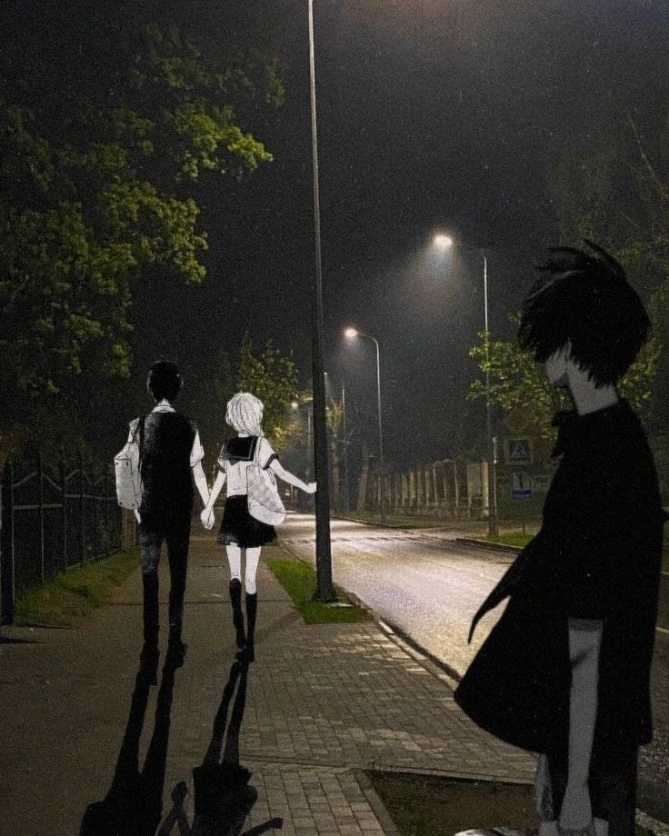 three people are walking down the sidewalk at night with one person dressed as a ghost