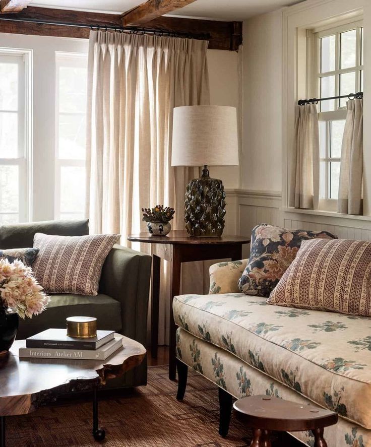 a living room with two couches and a coffee table in front of the window