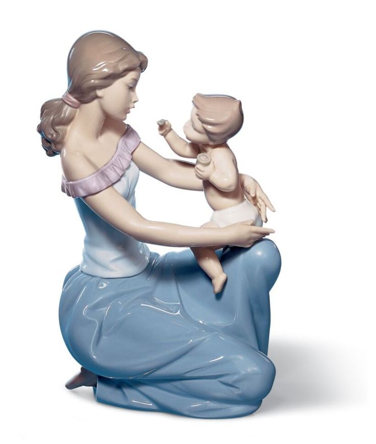 a figurine of a woman holding a baby