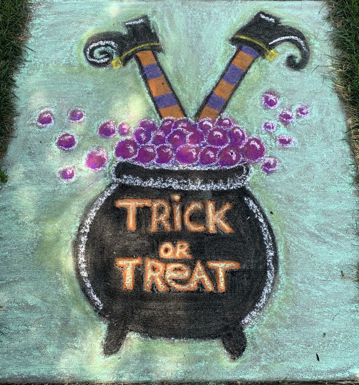 a chalk drawing of a witches caulder with trick or treat written on it