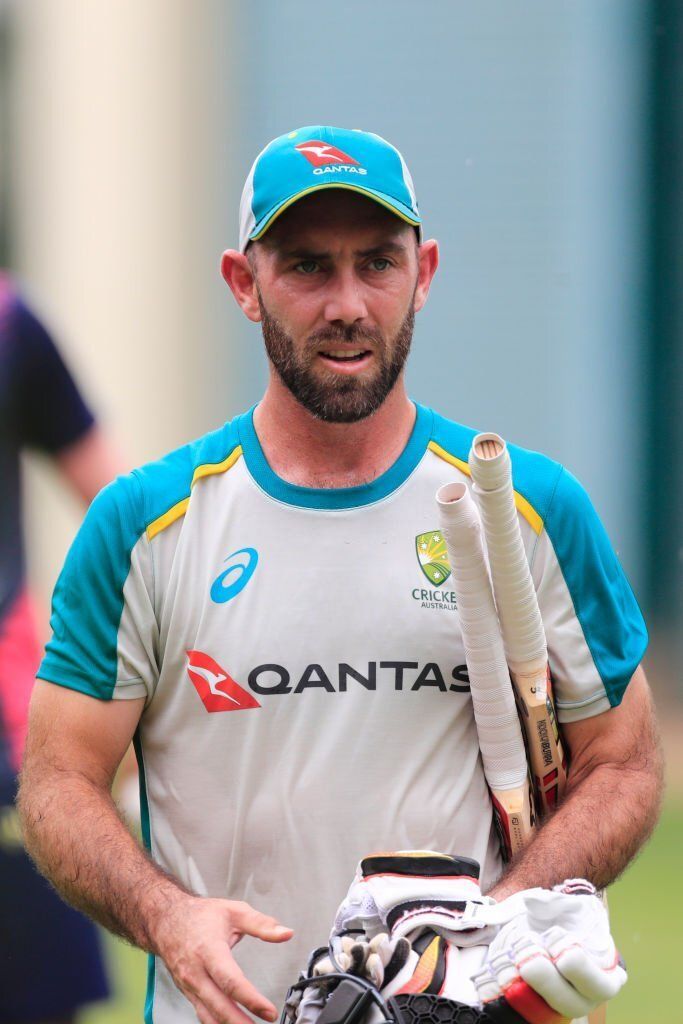 a man holding a baseball bat and glove