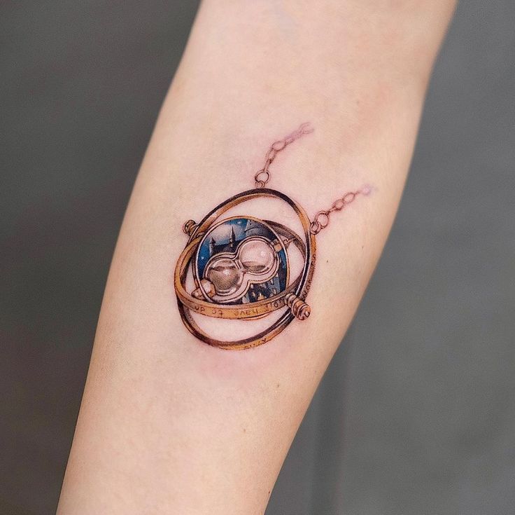 a tattoo on the arm of a woman with a clock in it's center