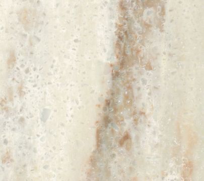 a close up view of some brown and white paint on a wall with water droplets all over it