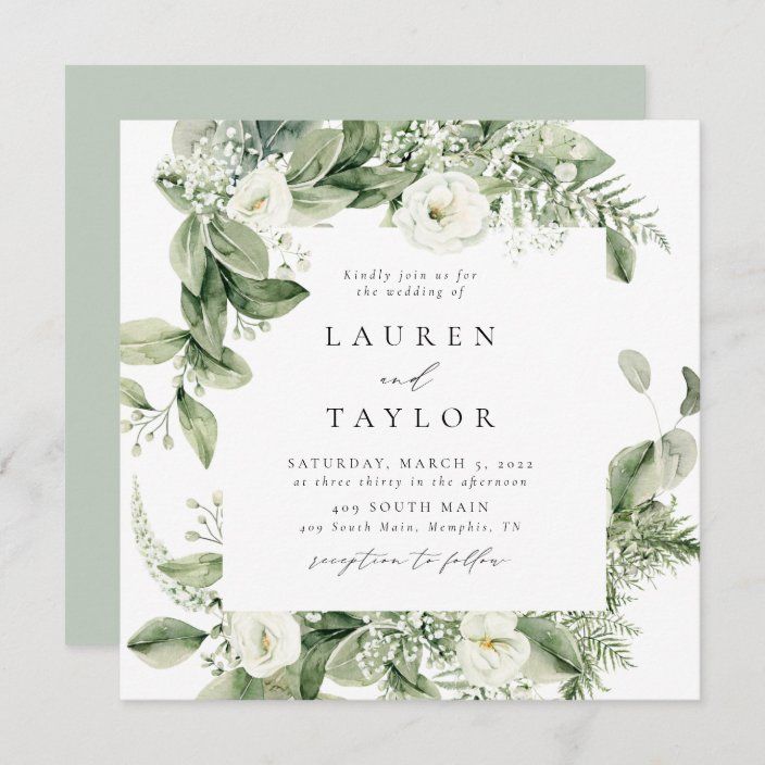 an elegant wedding card with greenery and white flowers on the front, is shown