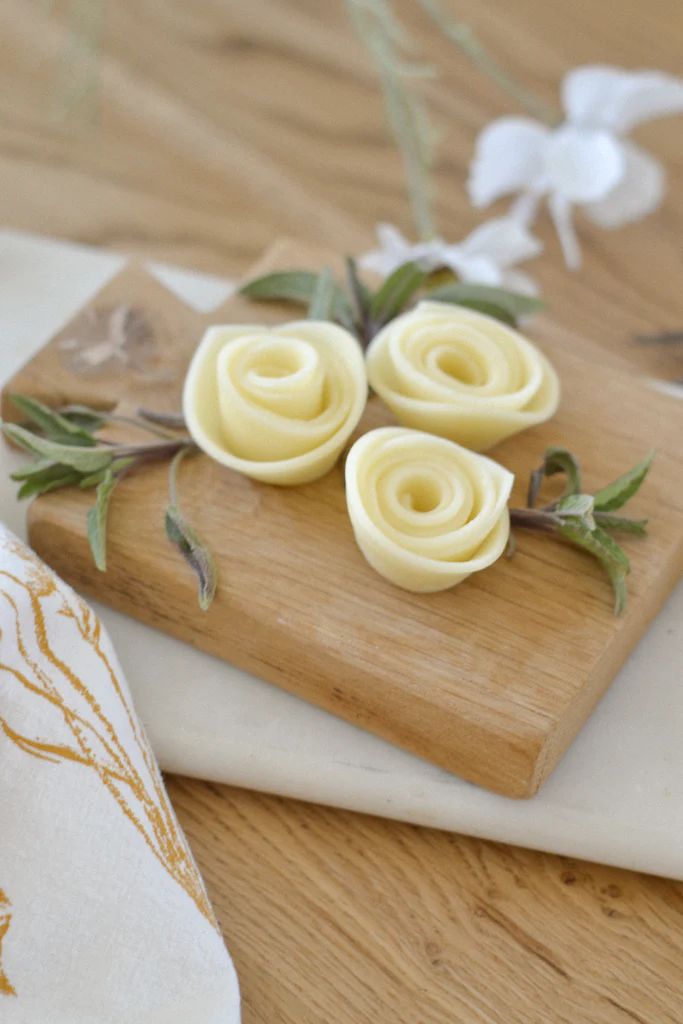 some flowers are sitting on a cutting board