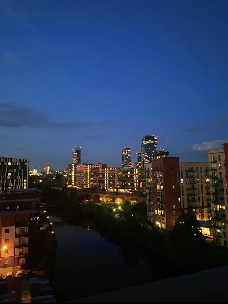 the city skyline is lit up at night