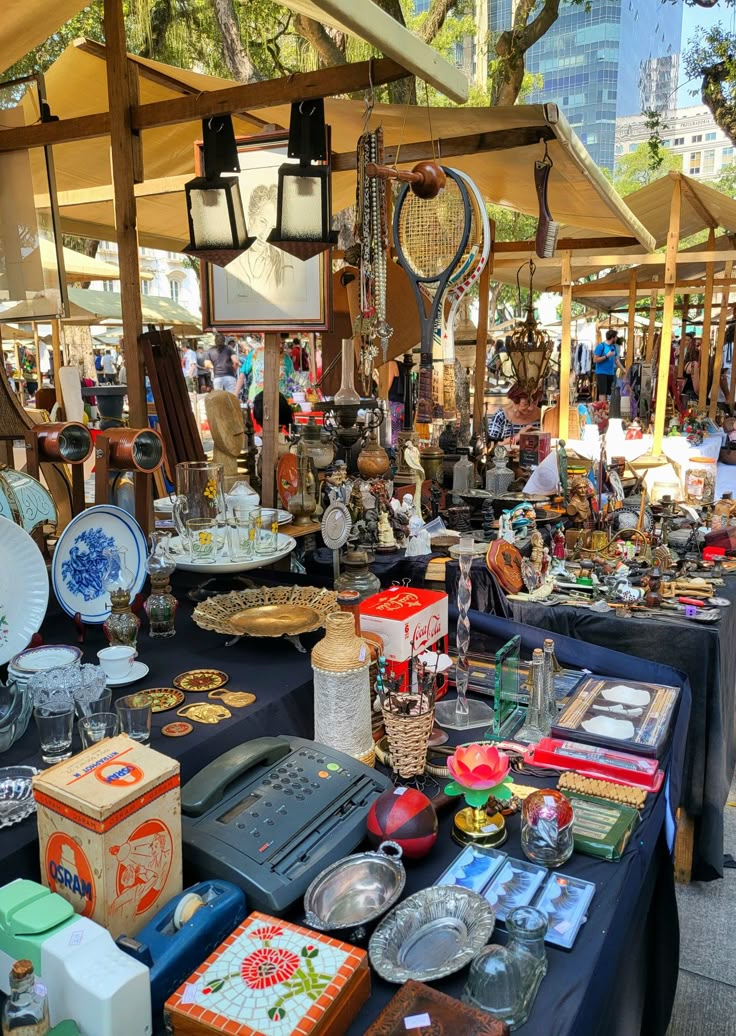 an outdoor market with lots of items on the table