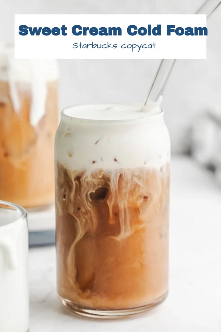 an iced drink in a mason jar with strawberries and whipped cream on the top