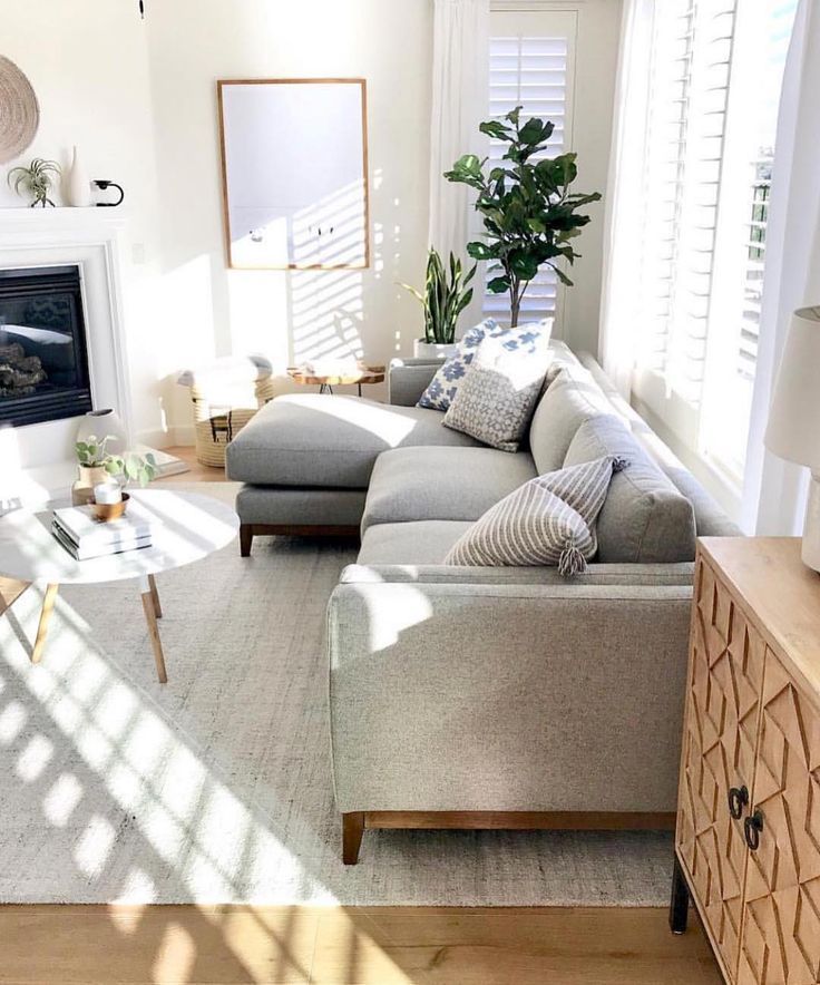 a living room filled with furniture and a fire place in the middle of a room