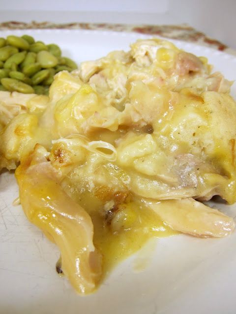 a white plate topped with green beans and macaroni and cheese covered in gravy