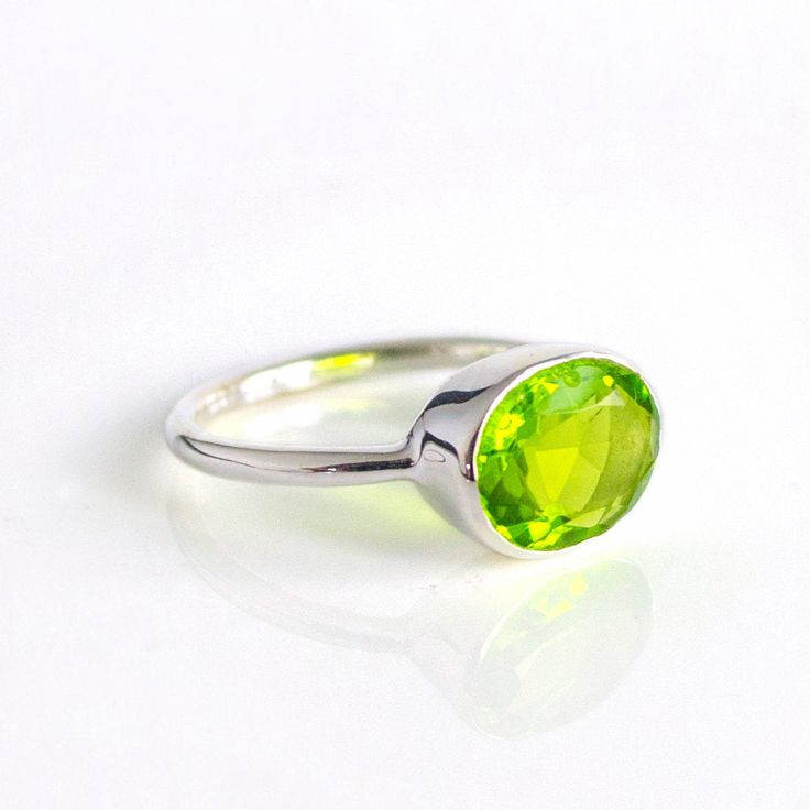 You'll fall in love with the intense grass-green color of this Peridot Quartz ring. This is a perfectly sized oval to compliment any collection. Popular as a birthday gift for those August babes and peridot lovers alike. This is a bright, transparent green gemstone with no flaws. This stone is beautifully faceted and bezel set in a 925 sterling silver band or plated with 18k vermeil gold. Gemstone is approximately 8 x 12mm.Band has 925 stamp on inside.Please note that each ring is handmade and t Stackable Gemstone Rings, August Birthstone Ring, Green Gemstone Ring, Peridot Jewelry, Gold Vermeil Jewelry, August Birthstone Jewelry, August Birthstone, Peridot Ring, Green Peridot