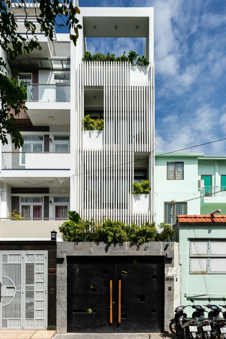 an apartment building with two garages and bicycles parked in front