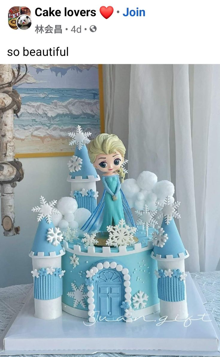 a frozen princess castle cake with snowflakes on it and a doll in the middle