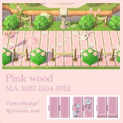 the pink wood has been decorated with white flowers and green grass, as well as an image