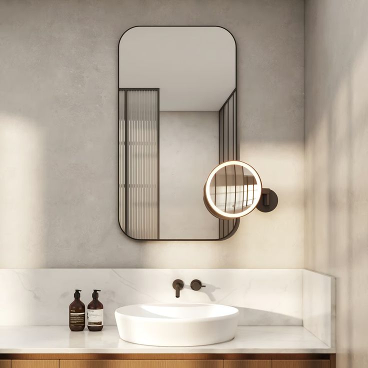 a bathroom with a sink, mirror and soap dispenser on the counter