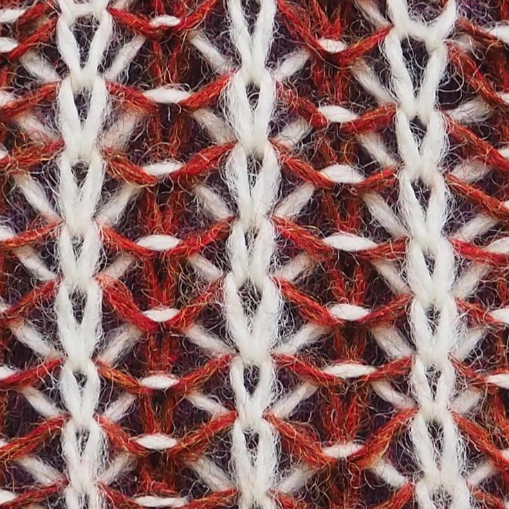 an image of a red and white knitted material with lines in the middle that appear to be woven or crochet