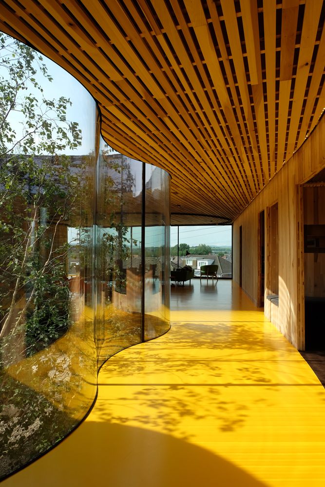 the inside of a building with yellow flooring and wooden slatted walls on both sides