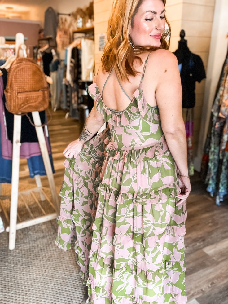 Get ready to turn heads with the Lina abstract floral maxi! This tiered maxi dress features a beautiful abstract floral print and ruffle detailing, adding a touch of whimsy to your look. Look effortlessly stylish and playful in this statement piece! relaxed fit small fits 0-6 medium fits 8-12 large fits 12-16 100% POLYESTER imported Pink Abstract Print Maxi Dress For Summer, Pink Maxi Dress With Abstract Print For Summer, Bohemian Maxi Dress With Ruffle Hem And Straps, Floral Print Maxi Dress With Ruffled Straps For Vacation, Flowy Breezy Maxi Dress With Ruffles, Bohemian Maxi Dress With Ruffled Straps, Breezy Tiered Skirt Maxi Dress, Bohemian Spring Dress With Ruffled Straps, Pink Maxi Dress With Ruffled Straps For Vacation