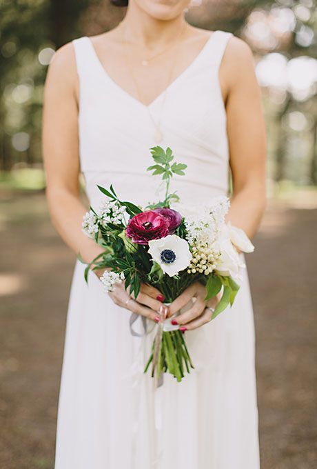 a woman in a white dress holding a bouquet of flowers on her left hand and an instagram button to the right