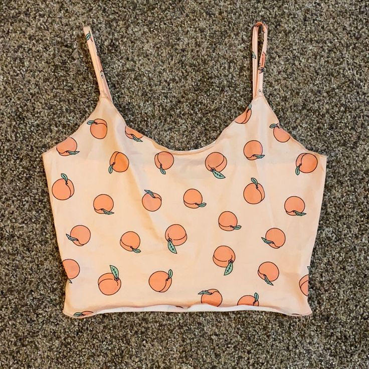 This Crop Top Is All Sorts Of Fun With Its Peach Print Design! It Has Spaghetti Straps And A Slightly Wavy Bottom! It’s Never Been Worn And Is Brand New! Fitted Peach Crop Top For Summer, Orange Camisole Tank Top For Spring, Orange Summer Crop Top For The Beach, Peach Sleeveless Crop Top For Spring, Spring Orange Cropped Crop Top, Spring Peach Sleeveless Crop Top, Sleeveless Peach Crop Top For Summer, Orange Summer Crop Top For Beach, Sleeveless Peach Crop Top For Spring