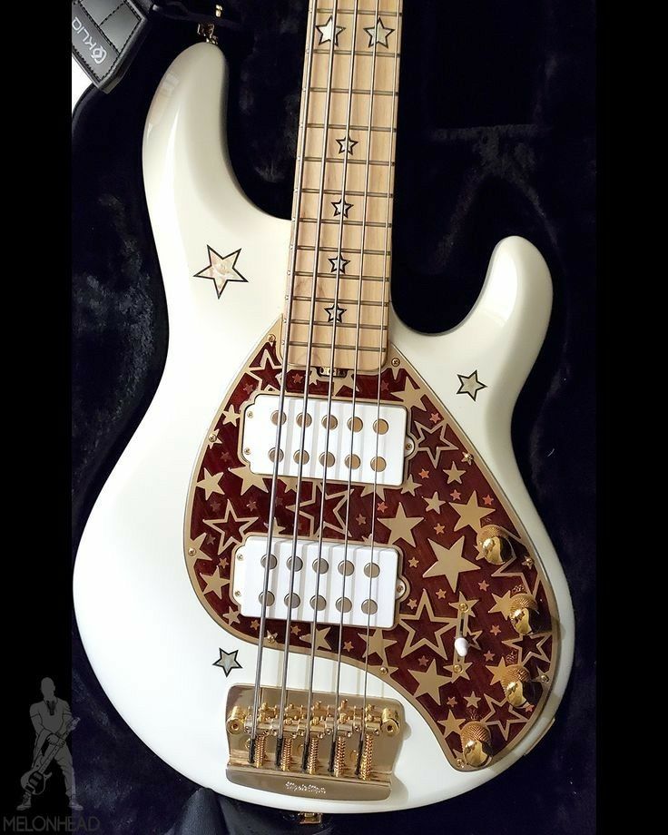 a white guitar with gold stars on it