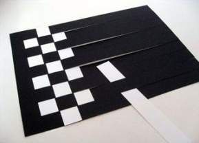 black and white paper cut into squares on a table