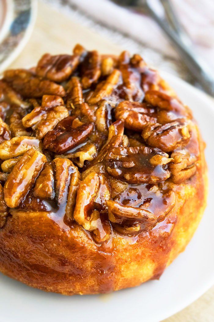 a pecan covered pastry on a white plate