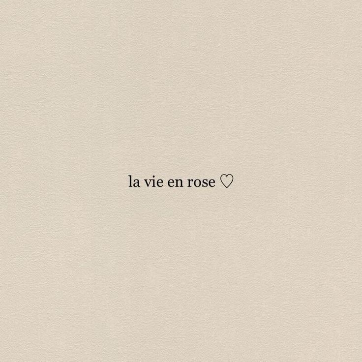 the word la vie en rose written in black ink on a white paper with a heart