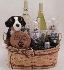 a dog is sitting in a basket with wine bottles