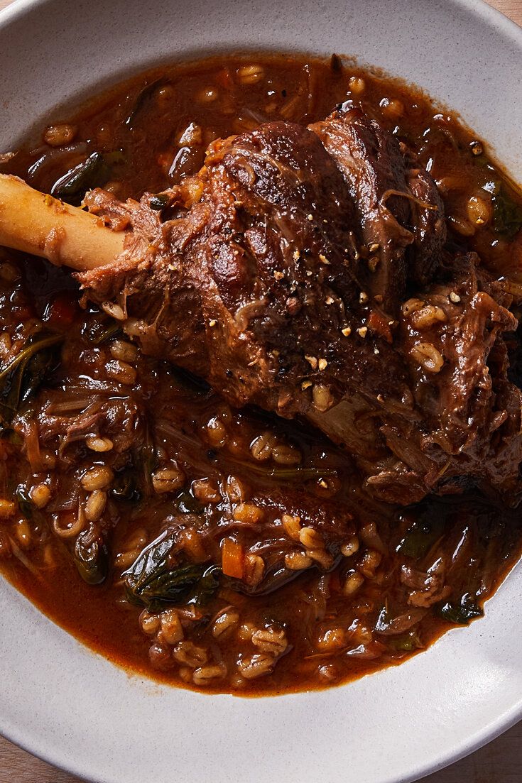 a white bowl filled with meat and beans