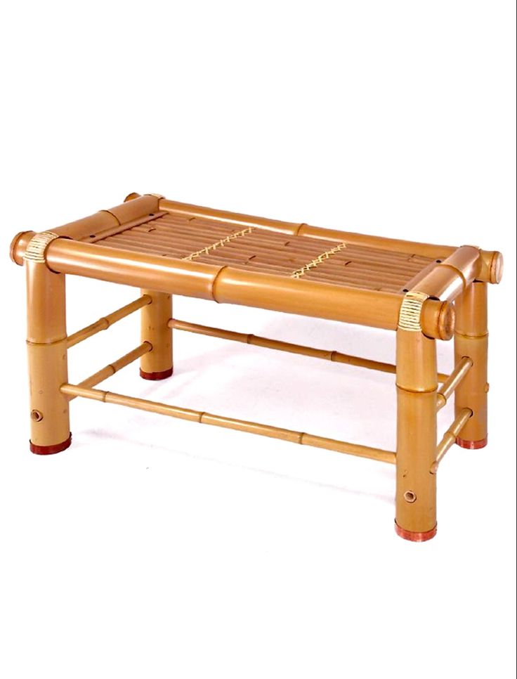 a small wooden bench made out of bamboo with two legs and one foot resting on it's side