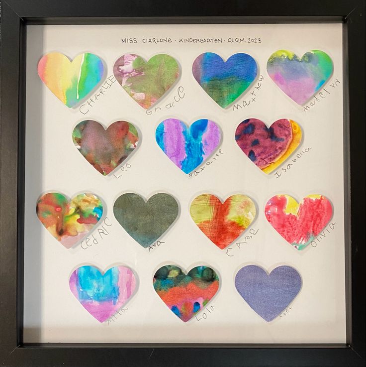 a shadow frame with different colored hearts in it