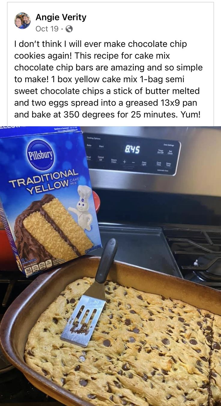 a pan filled with cake next to a box of chocolate chip cookies and a spatula