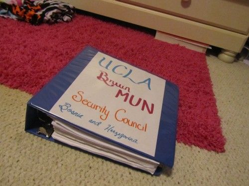 a book sitting on the floor in front of a child's bed and dresser