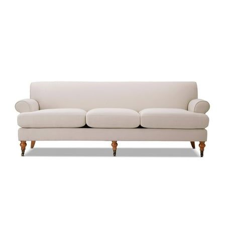 a white couch sitting on top of a wooden floor