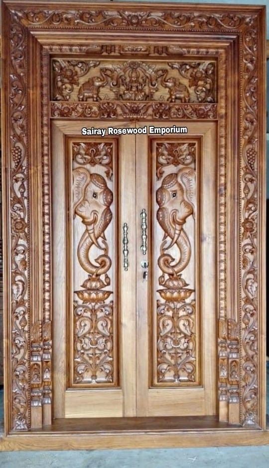 an ornate wooden door with carvings on it